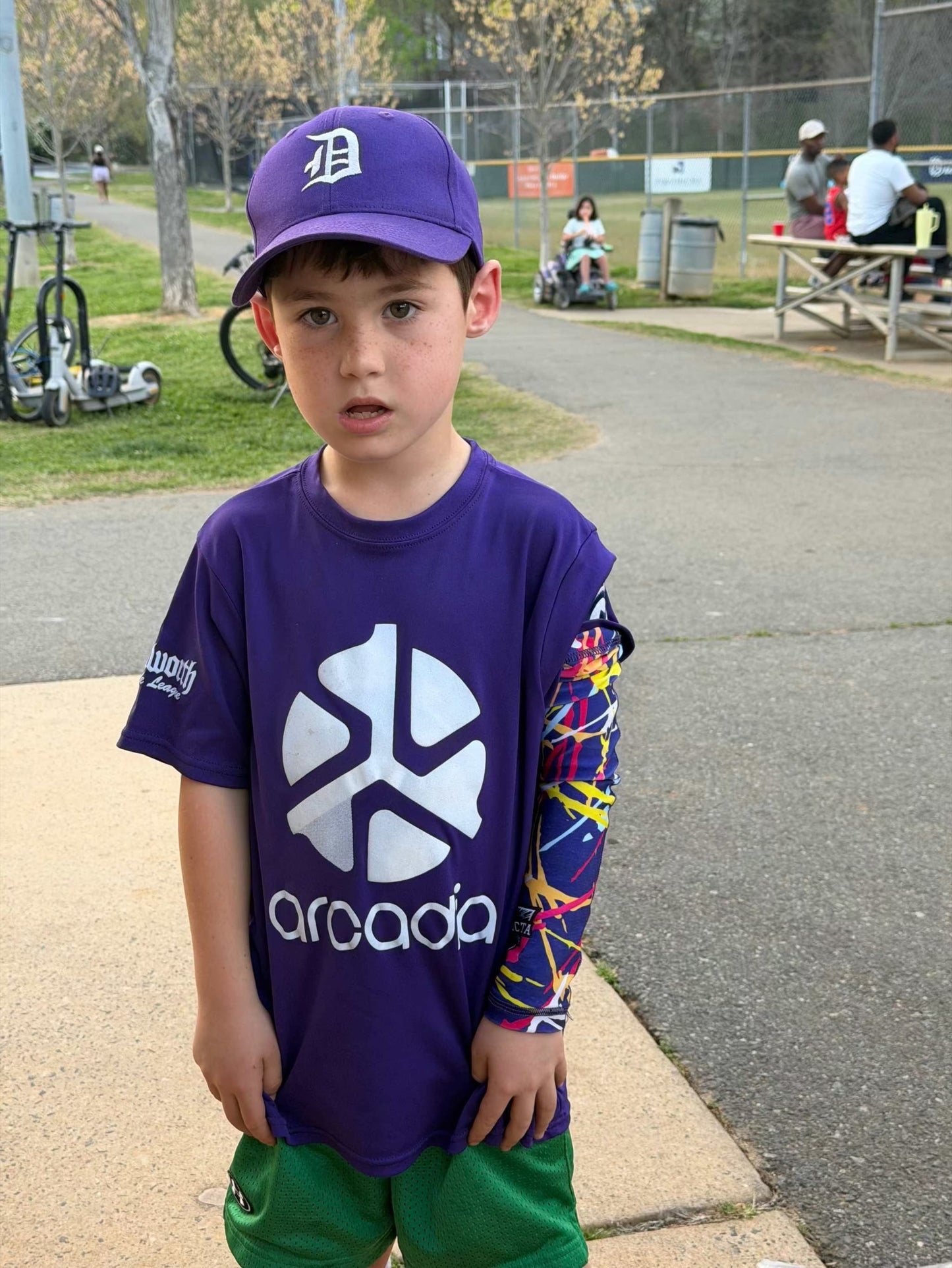 Athlete wearing Chaos Stroke Drip sublimation arm sleeves with vibrant design and UV protection